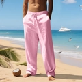 Close-up of pink linen casual trousers with adjustable drawstring waist on a sunny beach - Pink