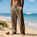 Detail of loose fit men's linen trousers with drawstring waist and natural texture - Coffee