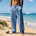 Men's light blue loose linen pants with drawstring waist in a beach resort setting - Denim Blue
