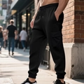 Detail of black jogger pants with waffle texture fabric and cargo pocket in outdoor setting - S / Bottoms / Black