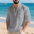 Detail shot of grey linen Henley shirt fabric texture and front pocket on beach background - Gray
