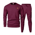 Detail of burgundy men's tracksuit set featuring a textured diamond knit pattern and leather patch - Burgundy