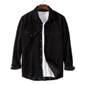 Close-up of black corduroy shirt texture with classic buttoned chest pockets and collar - Black