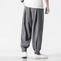Back view of men's loose linen harem pants in grey with tapered buttoned cuffs - Gray