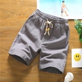 Men's grey cotton linen shorts with drawstring waist on dark wooden background - L / Gray