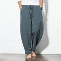 Detail view of deep grey linen harem pants featuring elastic waist and drawstring - M / Bottoms / Dark Green