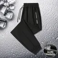 Men's black ice silk sports pants featuring breathable mesh detail and elastic cuffs - Black Elastic Cuff