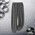 Men's ice silk trousers in dark grey featuring breathable fabric and zipped pockets - Gray Jogger