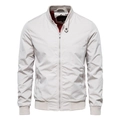 Detail of men's beige stand collar jacket showing red mesh lining and zipper pockets - M / Beige