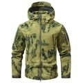 Detail of green camouflage tactical jacket showing waterproof fabric and multiple pockets - 3XL / Ruins Camouflage
