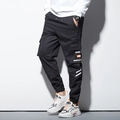 Pantalon cargo noir pour homme avec poches à rabat et détails de rayures blanches - M / Noir