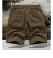 Back view of dark brown cotton cargo shorts with elastic waist and leather patch detail - M / Bottoms / Dark Brown