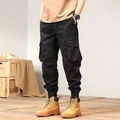 Black cargo pants for men with elastic waist, multi-pocket design, and zippered cuffs - EU 29 / Black