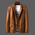 Detailed close-up of brown PU leather blazer featuring notched lapels and large patch pockets - 6XL / Earthy Yellow