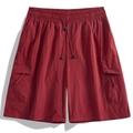 Detailed view of drawstring elastic waistband and flap cargo pocket on dark red shorts - S / Vermilion Red