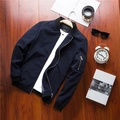 Flat lay of navy blue men's bomber jacket with ribbed collar on a wooden background - M / Blue