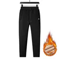 Detail view of men's thermal fleece joggers featuring drawstring waist and ribbed cuffs - L / Black Straight Leg