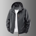 Chaqueta cortavientos para hombre con capucha y bolsillos con cremallera en gris carbón - M / gris oscuro