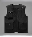 Close-up of black tactical vest with multiple flap pockets and breathable mesh lining - M / Black