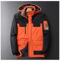 Detail of orange and black outdoor jacket featuring fleece lining and zipper pockets - L / Orange Red