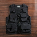 Close-up of black tactical utility vest showing durable pockets and breathable mesh lining - M / Black