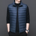 Men's lightweight navy blue down vest with stand collar and zipper closure over black sweater - S / Sapphire Blue