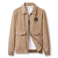Men's khaki corduroy bomber jacket with badge detail and flap pockets on white background - M / Khaki