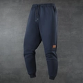 Men's navy blue fleece-lined sports jogger pants with drawstring waist and leather patch - XS / Blue