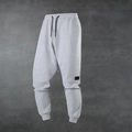 Pantaloni sportivi da uomo grigio chiaro con coulisse in vita e polsini elasticizzati - XS / Grigio chiaro