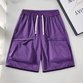 Men's purple cargo shorts featuring elastic drawstring waist and large side utility pockets - S / Purple