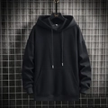 Men's black casual hoodie with kangaroo pocket and drawstring on industrial background - M / Black