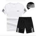 Men's white short sleeve t-shirt and black sports shorts set with side stripe details - M / White