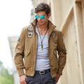 Men's khaki military bomber jacket with aviation patches and ribbed cuffs in outdoor setting - M / Khaki