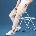 Men's light beige cargo pants featuring side flap pockets and elastic cuffs for a casual look - M / Khaki