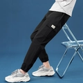 Men's black cargo joggers featuring large side pockets and HKS woven label decoration - M / Black