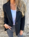 Close-up of the single-button closure and textured knit fabric on a slim black blazer - S / Black