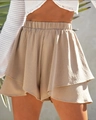 Detail of khaki tiered ruffle hem shorts with elastic high waist in sunny outdoor setting - S / Khaki