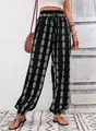 Detail view of ethnic geometric print harem pants with drawstring elastic waist and cuffs - S / Black