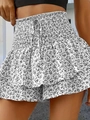 Detail of smocked high waist floral shorts with ruffled hem and decorative drawstring - S / Bottoms / White