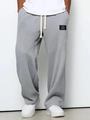Close-up of gray waffle knit joggers featuring elastic waist with drawstring and brand label - S / Gray