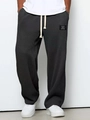 Detail of dark grey waffle texture lounge pants with drawstring and classic wear patch - S / Black