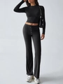 Close-up of ribbed texture on black long sleeve crop top and matching flared pants - S / Top And Bottom / Black