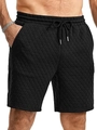 Macro shot of men's black quilted shorts showing elastic waistband and drawstring detail - S / Black