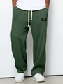 Detail of waffle knit fabric texture and classic white drawstring on men's green joggers - S / Dark Green