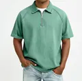 Detail of men's polo shirt featuring zipper neckline and textured raglan sleeve fabric - Green