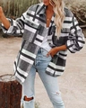Detail view of plaid shacket with flap pockets and button closure in outdoor setting - S / Gray