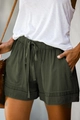 Detail of high-waist olive green linen shorts featuring a drawstring and utility pockets - S / Bottoms / Green