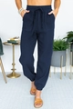 Detail view of navy blue high-waisted jogger pants with drawstring waist and textured fabric - S / Navy Blue