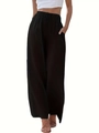 Dettaglio della vita elastica con coulisse e tasche laterali sui pantaloni neri a gamba larga - S / Nero