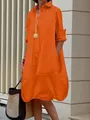 Detail view of the functional side pocket on this orange button-down midi dress - Orange